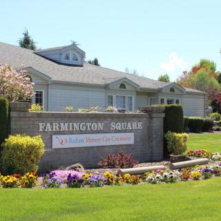 A landscaped entrance sign to a residential estate with flowers and greenery.