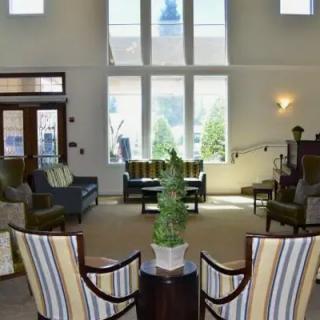 A modern lobby with comfortable seating and large windows.