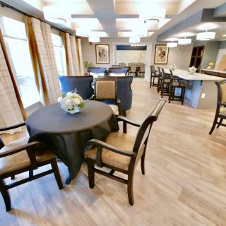 A modern dining area with tables and chairs arranged in a spacious layout.