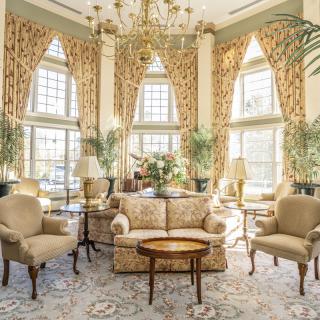 A luxurious living room with elegant furnishings and large windows.