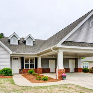 A suburban house with a gabled roof and double carport.