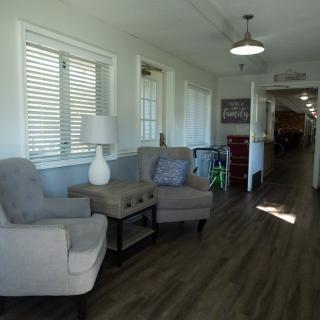 A cozy lounge area with chairs, a table, and decor in a corridor.
