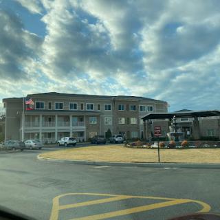 A hotel building set against a backdrop of cloudy skies.