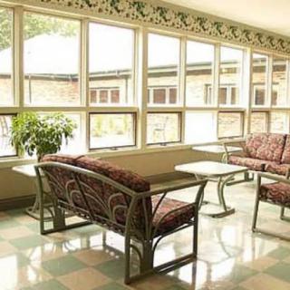 A bright lobby area with comfortable seating and large windows.