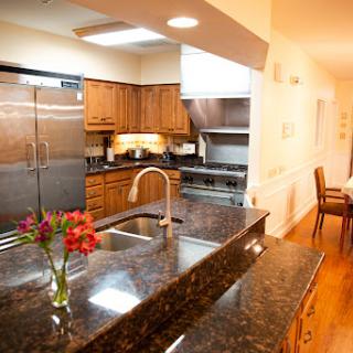 A modern kitchen featuring elegant wooden cabinets, sleek granite countertops, and modern appliances.