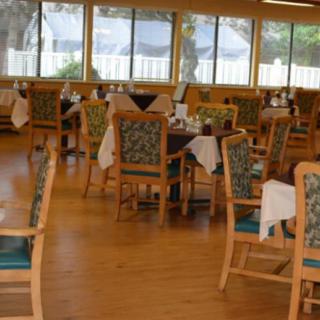 An empty restaurant dining area with tables and chairs set up.