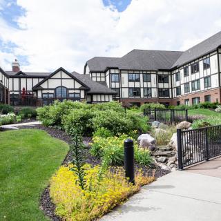 A beautiful residential building with a well-maintained garden and lush landscaping.