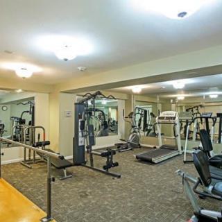 A well-equipped indoor gym with various exercise machines and weights.