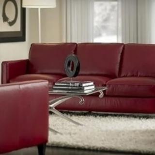 A modern living room with a red sofa and a stylish coffee table.