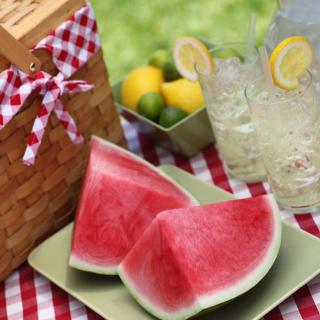 A refreshing summer picnic setup with watermelon slices and lemonade.