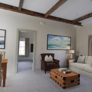 A cozy and modern living room with a couch, armchair, and wooden coffee table.