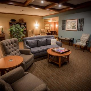 A cozy living room with comfortable seating and warm lighting.