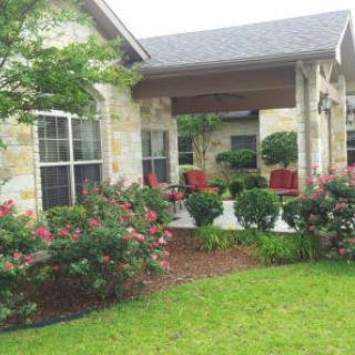 A cozy house with a well-maintained garden and patio area.