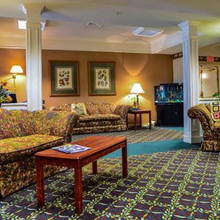 A cozy hotel lobby with patterned carpets and comfortable seating.