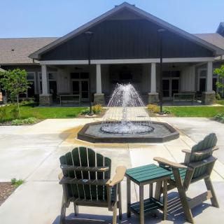 A serene outdoor space featuring a fountain and comfortable seating, perfect for relaxation.