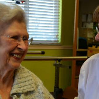A joyful moment shared between a senior woman and her caregiver.