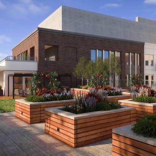 A contemporary building featuring a rooftop garden with wooden planters and large windows, set under a clear blue sky.