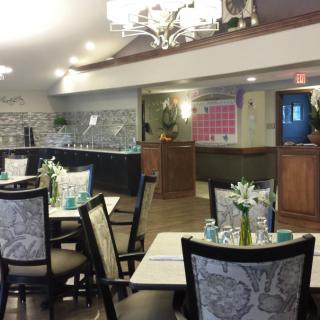 A cozy restaurant dining area with elegantly set tables and stylish chairs.