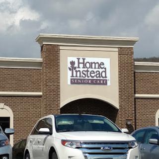 Exterior view of a Home Instead restaurant with cloudy skies overhead.
