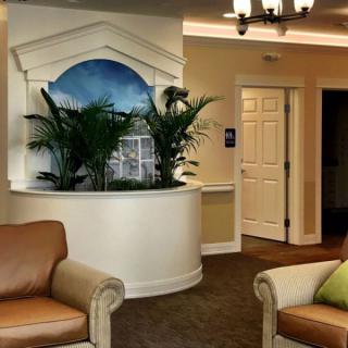A cozy lobby area featuring comfortable seating, decorative plants, and elegant interior design.