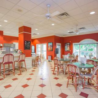 Bright and colorful cafe interior with dining tables and chairs.