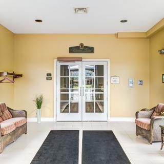 A cozy lobby area with sofas and double doors.