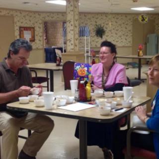 A group of people enjoying a meal together at a dining table.