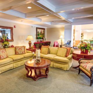 A cozy living room featuring a stylish sofa set, wooden coffee table, and elegant decor elements.