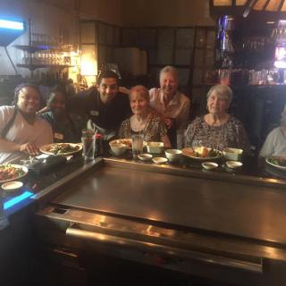 A group of friends enjoying a meal together at a restaurant.