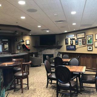 Cozy pub interior with tables and wall decor.