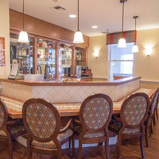 A cozy bar area with elegant wooden seating and warm lighting.
