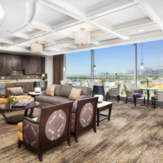 A spacious, modern living area with an open floor plan and a panoramic city view.