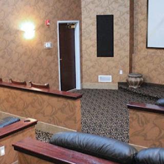 A cozy home theater setup featuring comfortable seating and a projector screen.