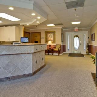 A welcoming reception area with a desk, seating, and neutral decor.