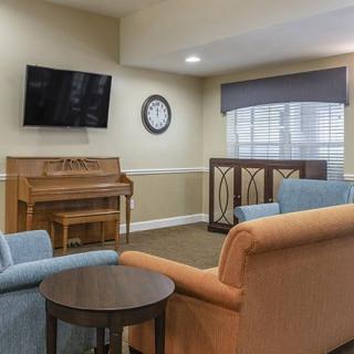 Cozy living room with piano and television.