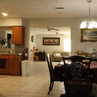 A view of a spacious open-concept home, showcasing the kitchen, dining area, and living room.