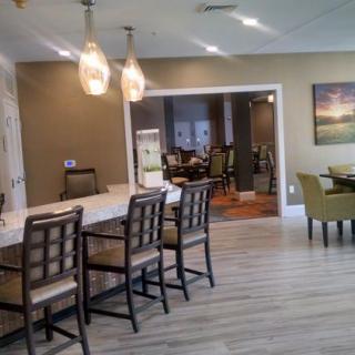 A modern dining area with bar seating and elegant lighting.