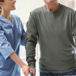 A nurse assisting an elderly patient with mobility.