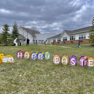 A cheerful Easter display featuring colorful decorations wishing everyone a Happy Easter.