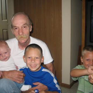 A man with three children indoors.