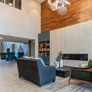 A modern living room with elegant furniture, a fireplace, and contemporary lighting.