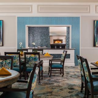 A stylish dining room with blue accents and elegant furnishings.