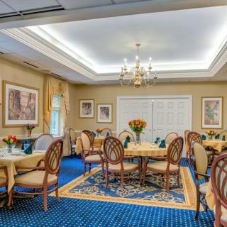 Elegant dining room with a chandelier and classic decor.
