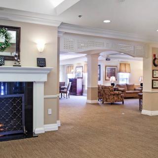 A cozy living room space with a fireplace and comfortable seating.