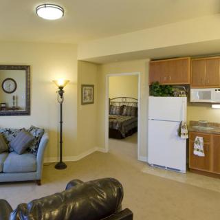 A cozy apartment with a living room and compact kitchen area.
