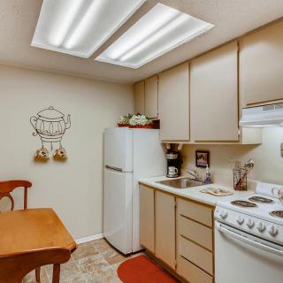 A cozy kitchen with modern appliances and wooden cabinetry.