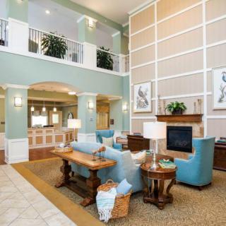 A spacious and elegantly decorated lobby with comfortable seating and a fireplace.