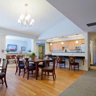 A modern dining area with an open kitchen layout and elegant lighting.