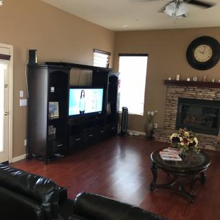 Cozy living room with a television and fireplace.