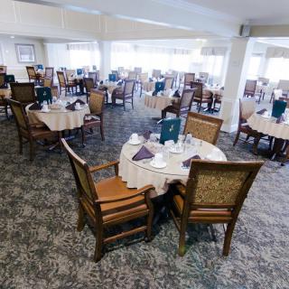 A spacious restaurant dining area with neatly set tables and chairs.